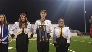 Members of the Darby Junior High Band holding a trophy 